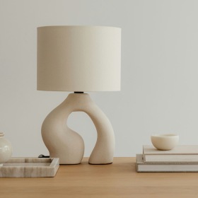 a table with a lamp and books