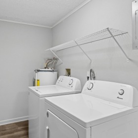 a washer and a dryer with wire shelving